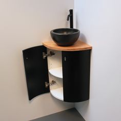 a black bowl sitting on top of a cabinet next to a sink