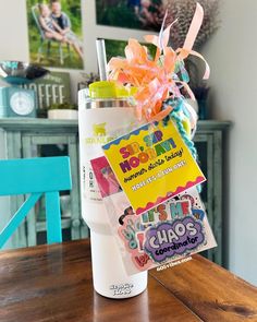 a cup with some stickers on it sitting on a table