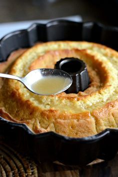 a close up of a cake in a pan with a spoon