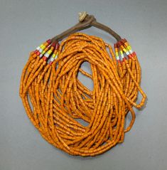 This ethnic necklace with 20 strands orange glass beads originates from the Naga.  The hanging length of the necklace is 28 cm. The average diameter of the beads is 0.3 cm.  Its weight is 203 gram. (s30) SHIPPING SHIPMENT is FREE. All items are shipped every week on monday morning after receipt of payment. We send priority airmails. Please consider overseas shipments take usually 5 - 8 days. Insured packets (over 50 cm length / over 1500 gram) I send by standard way. PAYMENT Paypal is preferred. Bohemian Orange Beads For Jewelry Making, Bohemian Orange Hand-strung Necklace, Artisan Orange Beaded Necklaces For Festivals, Hand-strung Orange Bohemian Beads, Bohemian Hand-strung Orange Beads, Orange Bohemian Hand-strung Beaded Necklace, Orange Multi-strand Hand-strung Jewelry, Traditional Multi-strand Polished Beads, Traditional Orange Beads For Crafting