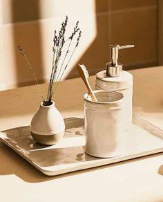 a bathroom set with soap dispenser, toothbrush holder and glass container