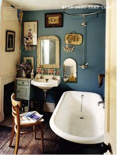 a bath room with a sink and a bath tub next to a mirror on the wall