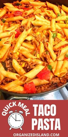 a skillet filled with taco pasta on top of a stove next to a clock