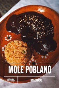 a plate with rice, beans and other food on it that says mole poblano mexico