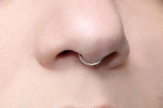 a woman with a nose ring on her nose