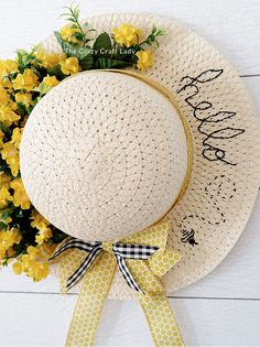 a white hat with yellow flowers on it and the words happy birthday written on it