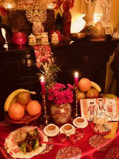 a table topped with lots of food and candles