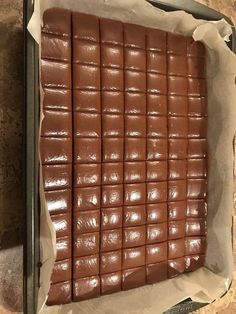 a pan filled with chocolate squares sitting on top of a counter