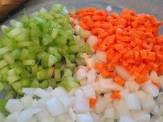 chopped vegetables are arranged in a bowl on the counter top, including carrots, celery, onions, and black beans