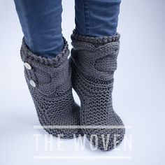 the woman is wearing gray knitted boots