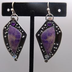 Gorgeous Purple Jade, Amethyst and Rainbow Moonstone set in sterling silver.  These earrings measure 2 3/8 inches long and 1 inch wide at the widest point.  All components are sterling silver and have been oxidized and polished. Each earring weighs:  10.2 grams Thanks for shopping!! Purple Jade, Nov 2, Rainbow Moonstone, Moonstone, 1 Inch, Springs, Etsy Earrings, Jade, Dangle Drop Earrings