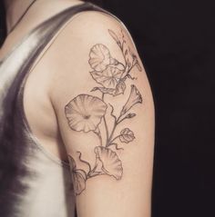 a woman's arm with a flower tattoo on it