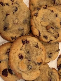 a pile of cookies sitting on top of a white paper towel covered in chocolate chips