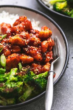 a plate full of chicken and broccoli with rice on the side, next to a fork