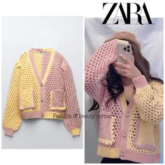 a woman taking a selfie while wearing a pink and yellow knitted cardigan