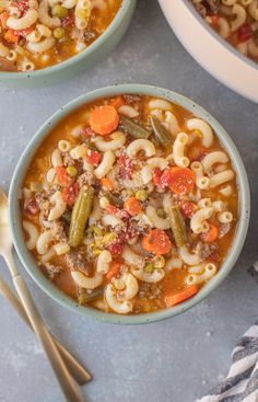 three bowls filled with pasta soup and vegetables