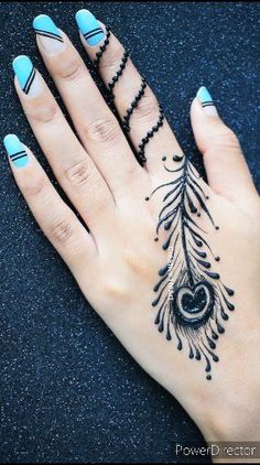 a woman's hand with a peacock tattoo on it