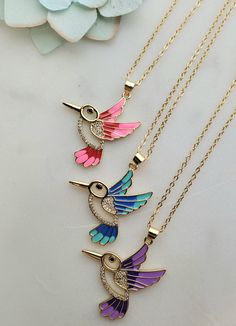 This stylish Hummingbird Necklace features a delicate hummingbird charm, made of sparkling bling that doubles as eye-catching ornamentation. An array of bright colors ensures heads will turn when this fashionable piece is worn. Hummingbird Necklace, Disney Jewelry, Bright Colors, Sparkle, Blue Color, Turn Ons, Collar, Disney, Pink