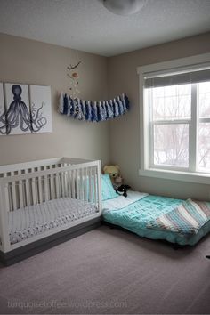 a baby's room with a bed, crib and pictures on the wall