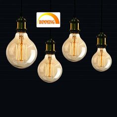 five light bulbs with dimming stickers hanging from the ceiling in front of a black background