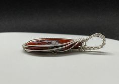 This unique Pendant has a combination of Red Jasper and Druzy Agate in Argentium Silver. Cabochon created by Monkeylion Designs. Approximately 2 1/8" long and 7/8" wide. Argentium silver contains a greater amount of pure silver (935 which contains 93.5% pure silver with the remainder being made up of other alloys, such as a small amount of germanium). This makes it more tarnish resistant than Sterling (.925) Silver. Red Agate Jewelry With Polished Finish, Jasper Cabochon Jewelry Gift, Jasper Cabochon Jewelry For Gifts, Cabochon Jasper Jewelry As Gift, Red Agate Pendant Jewelry, Unique Red Jasper Jewelry, Jasper Jewelry With Large Pendant As Gift, Oval Jasper Jewelry Gift, Oval Jasper Jewelry For Gifts