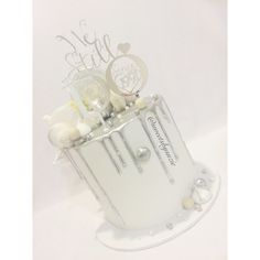 a white cake with flowers and candles on it's side, in the shape of a bucket