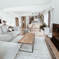 a living room filled with furniture and a flat screen tv sitting on top of a wooden table