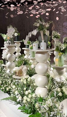 an arrangement of vases and flowers on display