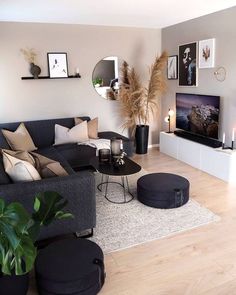 a living room filled with furniture and a flat screen tv on top of a wooden floor