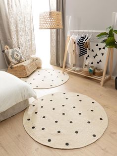 two round rugs with black and white polka dots are on the floor in front of a window