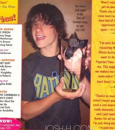 a young man holding up a cat in front of a magazine cover with the caption's name on it