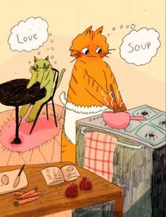 an orange cat sitting at a table in front of a book and some other items