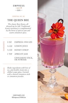 the queen bee cocktail is served in a coupe glass with an orange flower on top