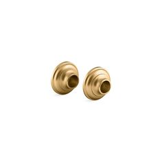 two gold colored knobs on a white background