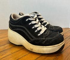 Here's a pair of Lower East Side sneakers from the 1990s! Feature a chunky platform heel. Look Kool when wearing these sneakers and stand out from the rest of the crowd. Condition: Good. Yellow staining through out the sole. Black upper material is flaking off. Sneakers are a little stiff from storage. Should all clean up nicely with the right care. Brand: Lower East Side Color: Black/White Size: 5 Please don't hesitate to ask any questions. Thanks for looking! Y2k Black, Lower East Side, Buffalo Ny, Chunky Platform, Platform Heel, Womens Tie, Black Sneakers, East Side, Tie Shoes