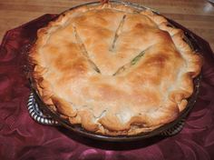 a pie sitting on top of a red table cloth