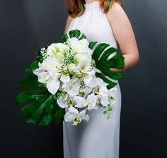 a woman in a white dress holding a bouquet of flowers