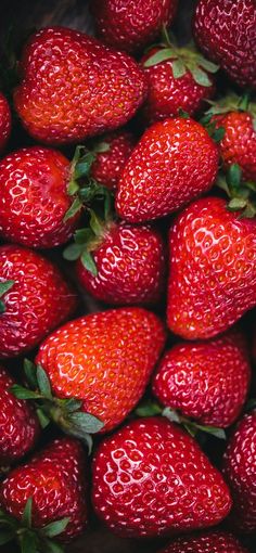 a pile of red strawberries sitting on top of each other