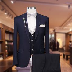 Package Includes: 1 x Jacket - 1 x Waistcoat - 1 x Pant

 	Fabric: 100% Wool
 	Yarn: 120s
 	Lining Fabric: Silk
 	Pattern: Solid
 	Construction: Half Canvas
 	Seasonality: All Season
 	Jacket: Pick Stitch Peak Lapel, Pick Stitch on Flap Pockets, Double Button Clouser
 	Waistcoat: V Shape 5 Button With Check on Lapel
 	Trouser: Flat front, side seam slant pockets, 2 Back Pockets, Zip Closure

Upgrade your style with our dark navy blue suit with vest. Experience unmatched sophistication and qualit Blue Suit With Vest, Dark Navy Blue Suit, Suit With Vest, Pick Stitch, Silk Pattern, Navy Blue Suit, Bespoke Suit, Peak Lapel, Fabric Silk