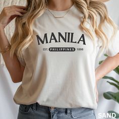 Manila Philippines Shirt, Manila Sweatshirt, Manila Filipino Shirt, Filipino University Student Shirt, Travel Shirt Filipino Patriotic Shirt Explore the fusion of heritage and style with our Manila Sweatshirt - a unisex, travel-inspired gem perfect as a gift for him or her. Represent Manila, Philippines in this college-style, Filipino American Sweatshirt, a proud emblem for every Filipino student or Philippines enthusiast. Showcase your Filipino pride with our Manila Philippines Shirt - a travel-inspired, Manila Sweatshirt designed for the globally-minded. This Manila Filipino Shirt, ideal for Filipino University Students, harmonizes patriotic flair and comfort in one unique, wearable statement. Summary of the product: Ideal for any situation, a unisex heavy blend crewneck sweatshirt is pu Casual Everyday Tops With Name Print, Casual Relaxed Fit Shirt With Name Print, Graphic Tee Shirt With Name Print In Relaxed Fit, Casual Cotton Shirt With Name Print, Relaxed Fit Graphic Tee With Name Print, Casual Long Sleeve Shirt With Name Print, Trendy Crew Neck Shirt With Name Print, Everyday Crew Neck Top With Name Print, Filipino Pride