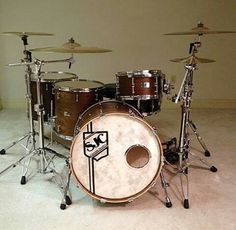 a drum set sitting on top of a white floor next to a pair of drums