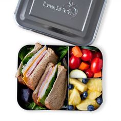 lunch box with sandwich, fruit and vegetables in it