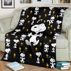 a black and white snoopy blanket on a chair