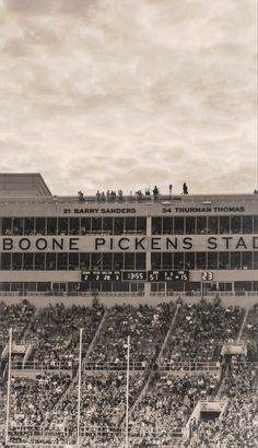 an old black and white photo of a football stadium