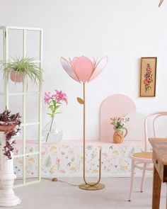 a room filled with furniture and flowers in vases