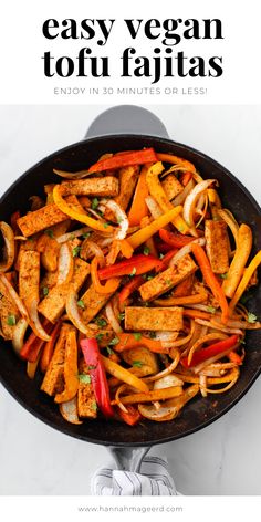 a skillet filled with tofu and vegetables on top of a white countertop