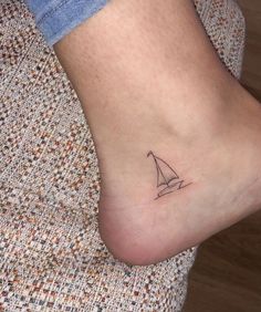 50 Best Small Travel Tattoos Ideas That Will Inspire Inner Wanderers Yacht Tattoo Design, Life Boat Tattoo, Sailboat Tattoo Minimalist, Boat Knot Tattoo, Sail Boat Tattoo Minimal, Fishing Boat Tattoo For Women, Dainty Nautical Tattoo, Sale Boat Tattoo, Sailboat Line Tattoo