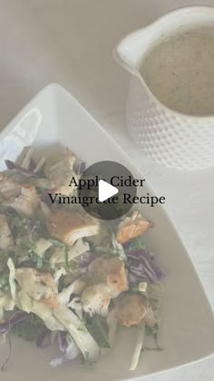 a white plate topped with salad next to a bowl of soup