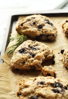 freshly baked cookies on a baking sheet ready to be eaten with rosemary sprigs