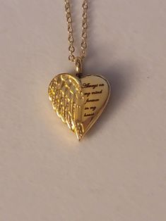 Gold Heart with Angel Wing Cremation Urn says Always On My Mind, Forever In My Heart.  Necklace comes with everything needed to help you get the ashes into the urn.  ** We also have this necklace available in silver.  Heart urn is stainless steel and comes on a 20inch gold stainless steel chain.  To personalize this necklace please check out our "ADD On" section.  Simply go to the search bar on our shop's homepage.   Once there type "Add On" into the search bat.  If you find anything you like you can add it to your cart along with this necklace.   Once everything is in your cart you can select "purchase" to make your purchase.  Please feel free to message us with any questions you may have.   We would be happy to help you.  Thank you so much. Heart Shaped Necklaces For Valentine's Day Commemoration, Heart-shaped Necklaces For Valentine's Day Commemoration, Heart-shaped Necklace For Valentine's Day Commemoration, Heart Necklace For Valentine's Day Commemoration, Personalized Heart Shaped Jewelry For Commemoration, Meaningful Heart-shaped Keepsake Necklace, Inspirational Gold Heart Jewelry, Inspirational Heart-shaped Gold Jewelry, Gold Heart Charm Necklace For Memorial